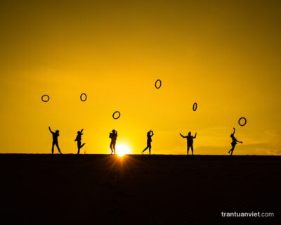 Children play with old tires on the sand dune in Mui Ne, Binh Thuan, Vietnam
