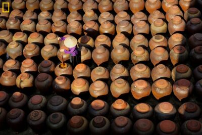 A woman between jars of soy sauce