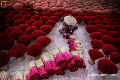 Woman collects bundles of incense stick, National Geographic Magazine